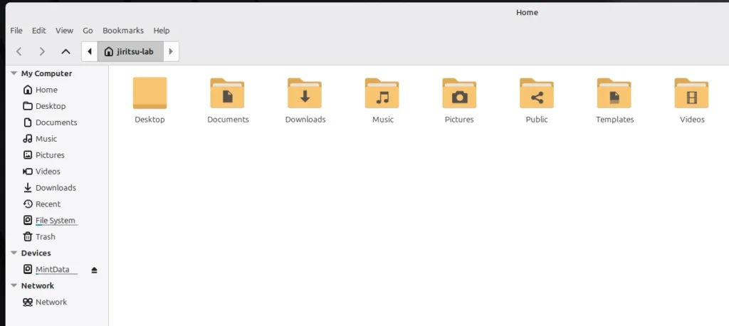 Linux Mint file manager window showing the Home folder with Desktop, Documents, Downloads, Music, Pictures, and Videos